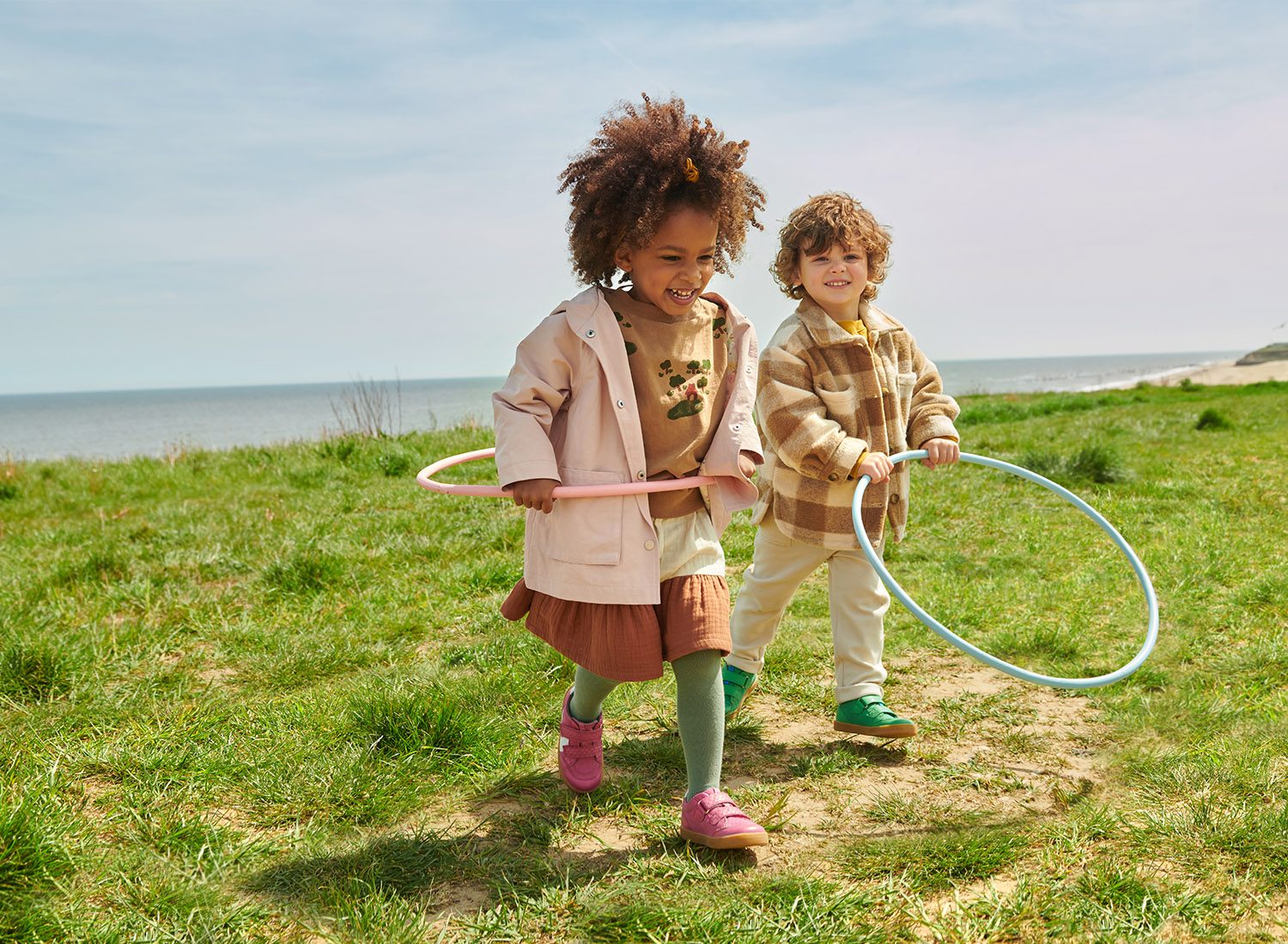 2 children playing with hoops